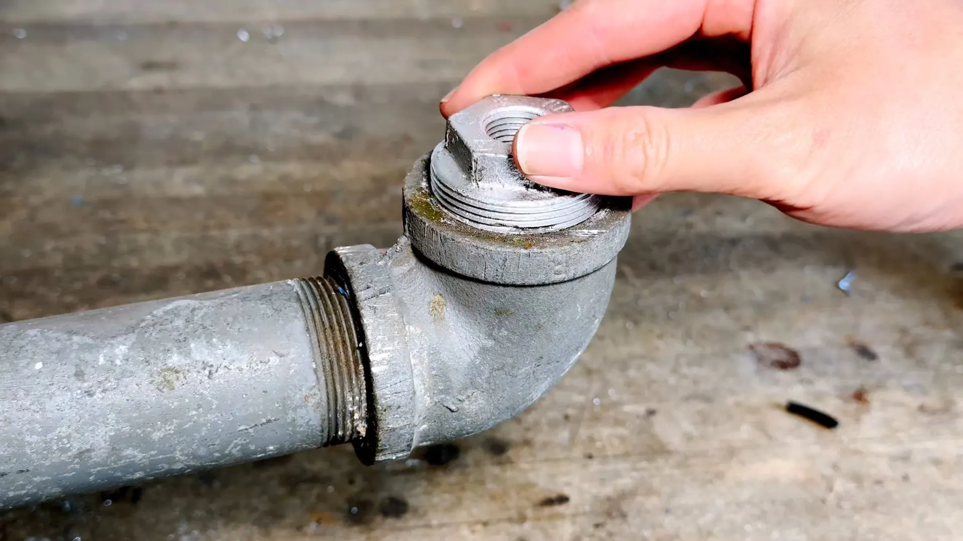 Hand turning a stuck galvanized cleanout cap