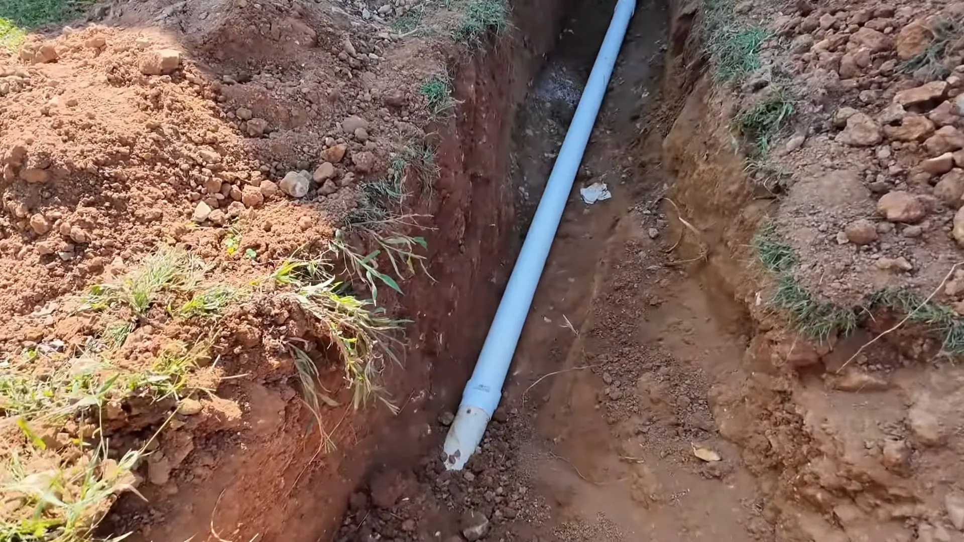 Replacement pipe laid in an open dirt trench